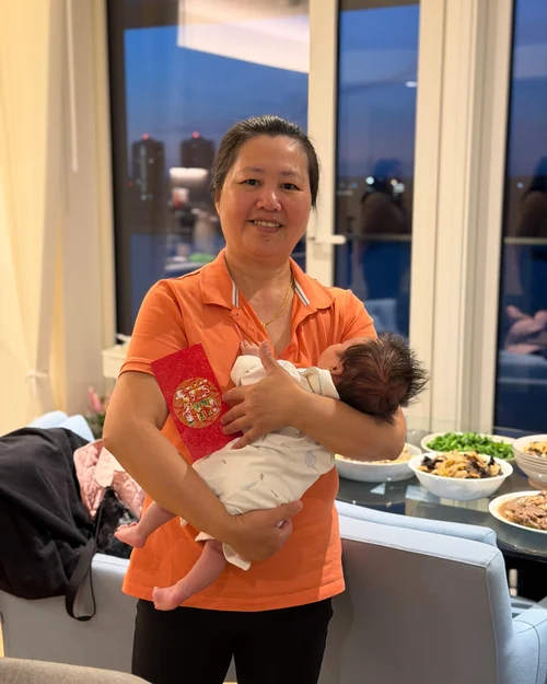 Jenny Wu holding a settled newborn